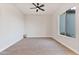 Simple bedroom with large window and neutral color scheme at 22859 W Euclid Ave, Buckeye, AZ 85326