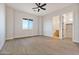 Bedroom with ceiling fan, large window, and en-suite bathroom at 22859 W Euclid Ave, Buckeye, AZ 85326