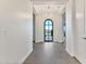 Open and airy entryway with arched door and wood floors at 22859 W Euclid Ave, Buckeye, AZ 85326