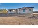 Single-story home with stone accents and a tile roof.Landscaped yard with walkway at 22859 W Euclid Ave, Buckeye, AZ 85326