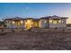 Stunning ranch house exterior at dusk, featuring stone accents and a welcoming entryway at 22859 W Euclid Ave, Buckeye, AZ 85326