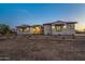 Beautiful ranch home with stone accents at dusk at 22859 W Euclid Ave, Buckeye, AZ 85326