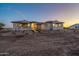 Evening view of a charming ranch home's exterior at 22859 W Euclid Ave, Buckeye, AZ 85326