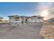 Single-story home with stone accents and a tile roof.Landscaped yard with walkway at 22859 W Euclid Ave, Buckeye, AZ 85326