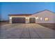 Two-car garage with dark-stained wooden doors at 22859 W Euclid Ave, Buckeye, AZ 85326