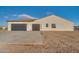 Side view of house showcasing two-car garage and landscaping at 22859 W Euclid Ave, Buckeye, AZ 85326