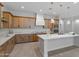 Bright kitchen featuring an island, light wood cabinets, and quartz countertops at 22859 W Euclid Ave, Buckeye, AZ 85326