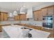 Modern kitchen with large island, stainless steel appliances, and white quartz countertops at 22859 W Euclid Ave, Buckeye, AZ 85326