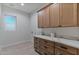 Laundry room with wood cabinets and quartz countertops at 22859 W Euclid Ave, Buckeye, AZ 85326