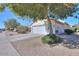 Side view of single story house with white exterior, two-car garage, and desert landscaping at 2490 E Fiesta Dr, Casa Grande, AZ 85194