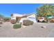 Front view of single story house with white exterior, two-car garage, and desert landscaping at 2490 E Fiesta Dr, Casa Grande, AZ 85194