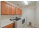 Bright laundry room with cabinets and space for a washer and dryer at 2490 E Fiesta Dr, Casa Grande, AZ 85194