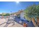 Backyard patio with seating area and a grill at 26409 S Moonshadow Dr, Sun Lakes, AZ 85248