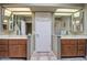 Double vanity bathroom with a large mirror and tiled floors at 26409 S Moonshadow Dr, Sun Lakes, AZ 85248