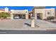 A two-car garage with a car parked inside and golf cart at 26409 S Moonshadow Dr, Sun Lakes, AZ 85248