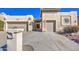 House exterior showcasing a two-car garage and Spanish-style architecture at 26409 S Moonshadow Dr, Sun Lakes, AZ 85248