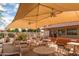 Covered patio with tables and chairs at 26409 S Moonshadow Dr, Sun Lakes, AZ 85248