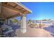 Spacious patio with seating area, fire pit, and lake view at 26409 S Moonshadow Dr, Sun Lakes, AZ 85248