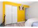 Bedroom with double door closet and yellow walls at 2697 W Ocotillo Rd, Phoenix, AZ 85017