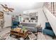 Spacious living room featuring a gray sofa and teal armchairs at 2697 W Ocotillo Rd, Phoenix, AZ 85017