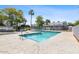 Community pool with surrounding patio and trees at 2697 W Ocotillo Rd, Phoenix, AZ 85017