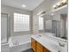 Bathroom with double vanity and glass block window at 2706 N 115Th Dr, Avondale, AZ 85392