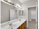 Double vanity bathroom with wood cabinets and mirrors at 2706 N 115Th Dr, Avondale, AZ 85392