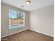 Bright bedroom with pool view and wood-look floors at 2706 N 115Th Dr, Avondale, AZ 85392