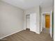 Simple bedroom with wood-look floors and a large closet at 2706 N 115Th Dr, Avondale, AZ 85392