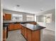 Kitchen with wood cabinets, dark countertops, and an island at 2706 N 115Th Dr, Avondale, AZ 85392