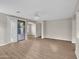 Living room with wood-look floors, ceiling fan, and access to patio at 2706 N 115Th Dr, Avondale, AZ 85392