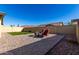 Backyard patio with seating and artificial turf at 2707 N Acacia Way, Buckeye, AZ 85396