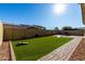 Artificial turf backyard with seating area and pathway at 2707 N Acacia Way, Buckeye, AZ 85396