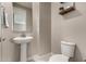 Powder room with pedestal sink and toilet at 2707 N Acacia Way, Buckeye, AZ 85396