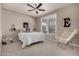 Bedroom with window, ceiling fan and chair at 2707 N Acacia Way, Buckeye, AZ 85396