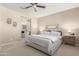 Main bedroom with en-suite bathroom access and ceiling fan at 2707 N Acacia Way, Buckeye, AZ 85396