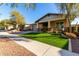 Beautiful home with artificial turf and mature trees at 2707 N Acacia Way, Buckeye, AZ 85396