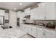 Modern kitchen with white cabinets, granite countertops and island at 2707 N Acacia Way, Buckeye, AZ 85396