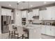 Modern kitchen featuring white cabinets, granite countertops, and stainless steel appliances at 2707 N Acacia Way, Buckeye, AZ 85396