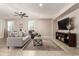 Bright living room featuring a cozy sofa, large TV, and stylish coffee table at 2707 N Acacia Way, Buckeye, AZ 85396