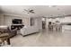 Open concept living room with gray couch and kitchen view at 2707 N Acacia Way, Buckeye, AZ 85396