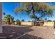 Landscaped backyard with gravel, mature trees, and desert plants at 2728 E Encanto Cir, Mesa, AZ 85213