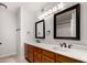 Bathroom with a double vanity, large mirrors, and wood cabinets at 2728 E Encanto Cir, Mesa, AZ 85213