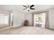 Bedroom with ceiling fan, sliding door to patio and mirrored closet at 2728 E Encanto Cir, Mesa, AZ 85213