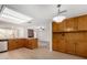 Kitchen with a breakfast bar, wood cabinets and view to living room at 2728 E Encanto Cir, Mesa, AZ 85213