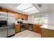 Galley kitchen with stainless steel appliances and wood cabinets at 2728 E Encanto Cir, Mesa, AZ 85213