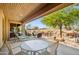 Relaxing covered patio with seating area and desert landscape views at 27506 N Montana Dr, Rio Verde, AZ 85263