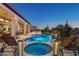 Inviting backyard with a sparkling pool, spa, and comfortable lounge seating at 29512 N Tarragona Dr, Peoria, AZ 85383