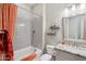 Stylish bathroom with a tub, gray tile, and orange shower curtain at 29512 N Tarragona Dr, Peoria, AZ 85383