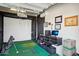 Finished garage with golf simulator and ample storage space at 29512 N Tarragona Dr, Peoria, AZ 85383